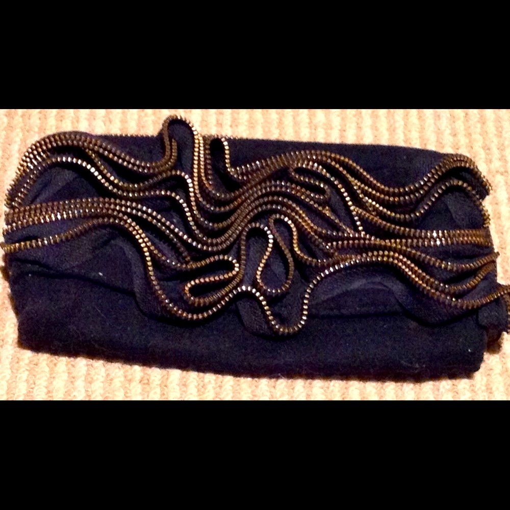Black cool zip designed front, clutch with tags